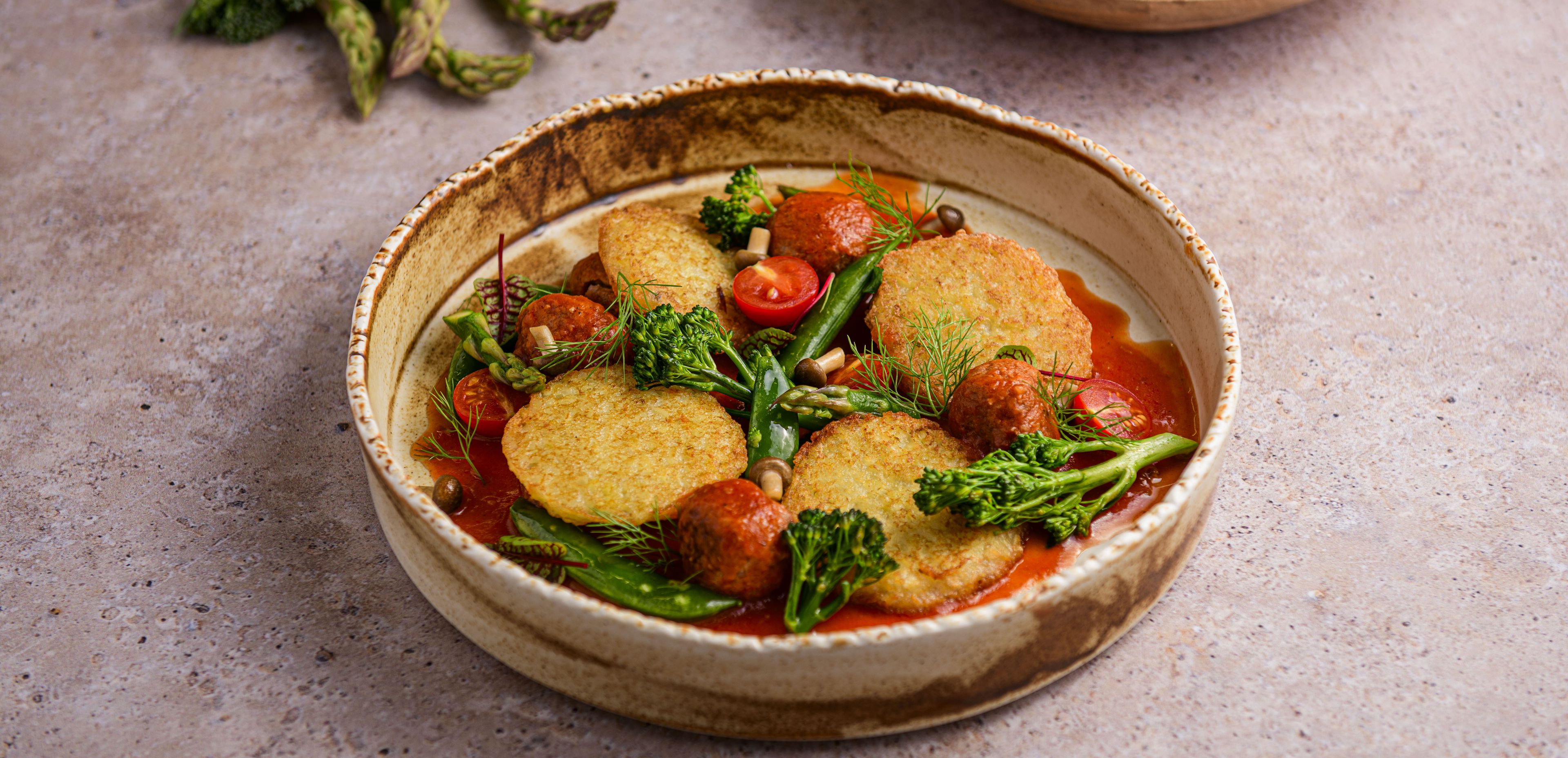 Mini potato pancakes with meatballs and vegetables