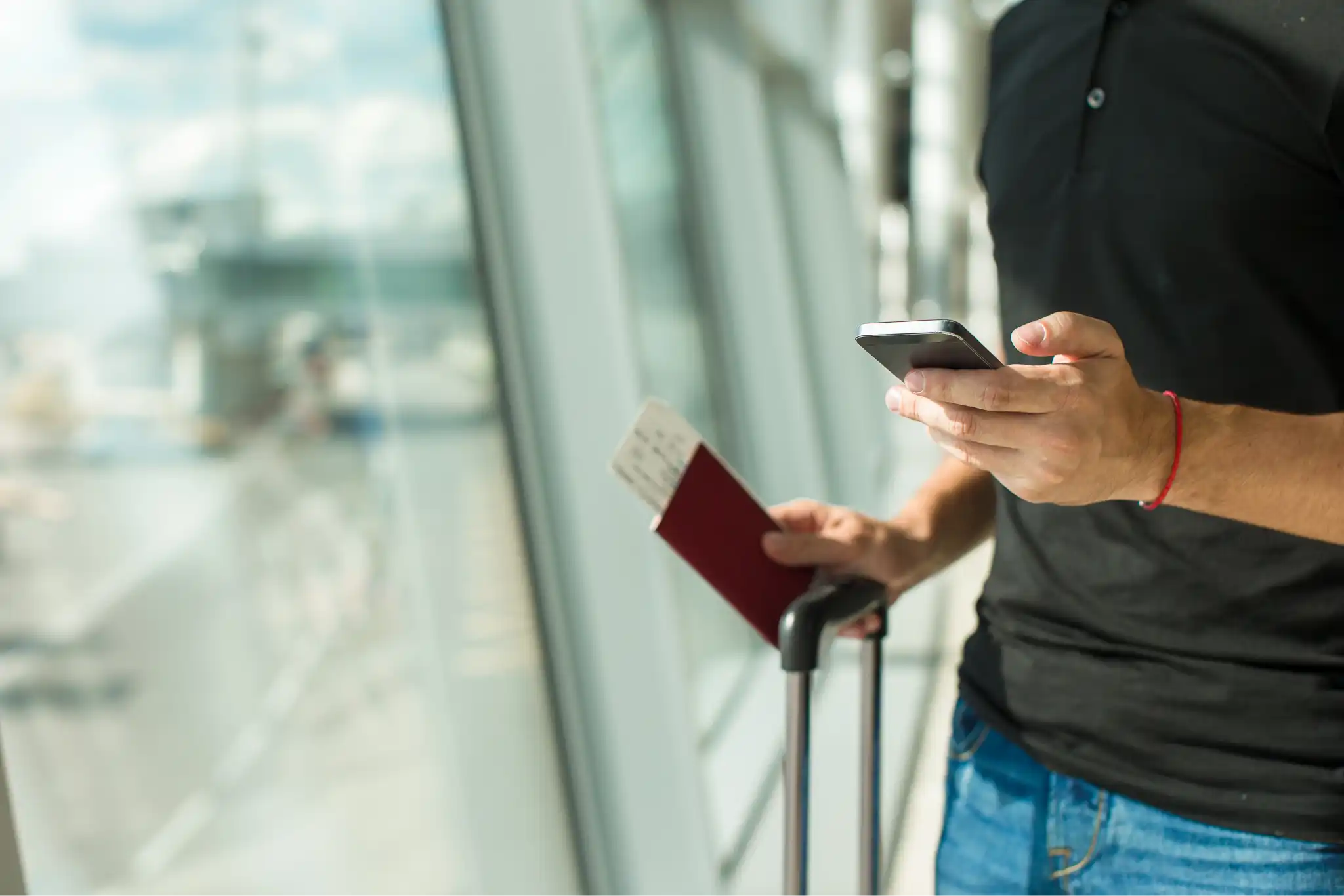 Someone using an eSIM to get access mobile internet in an airport - but which is the best eSIM?