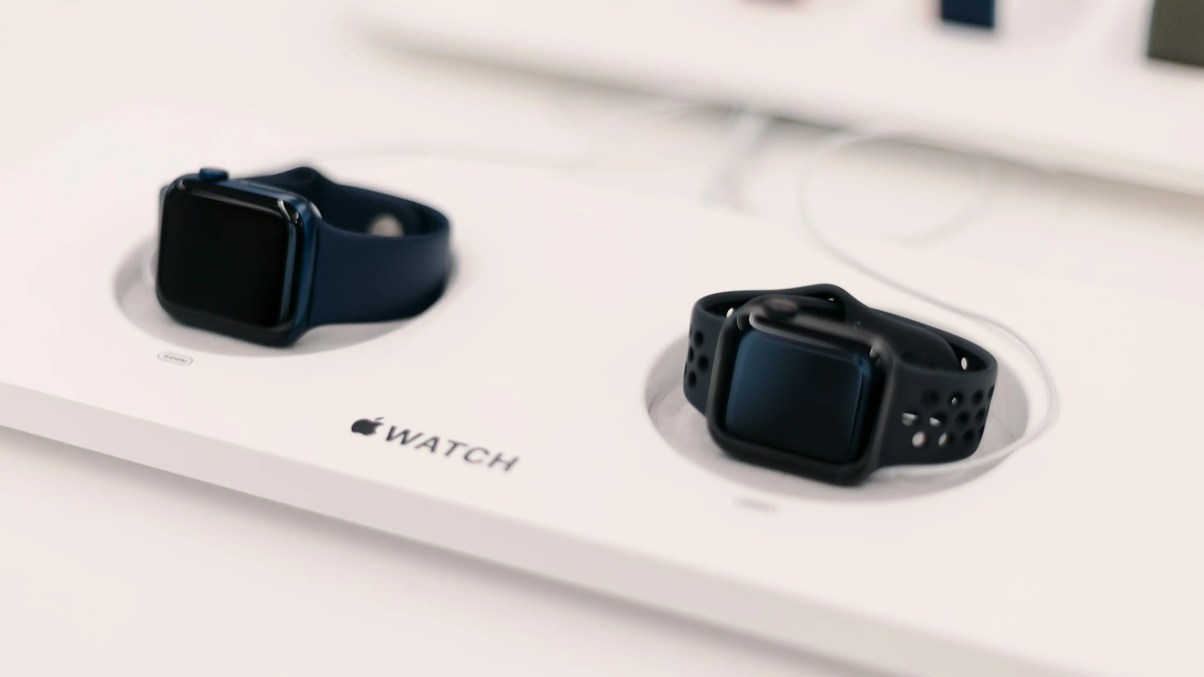 Two Apple Watches with different Apple Watch Bands in an Apple Store