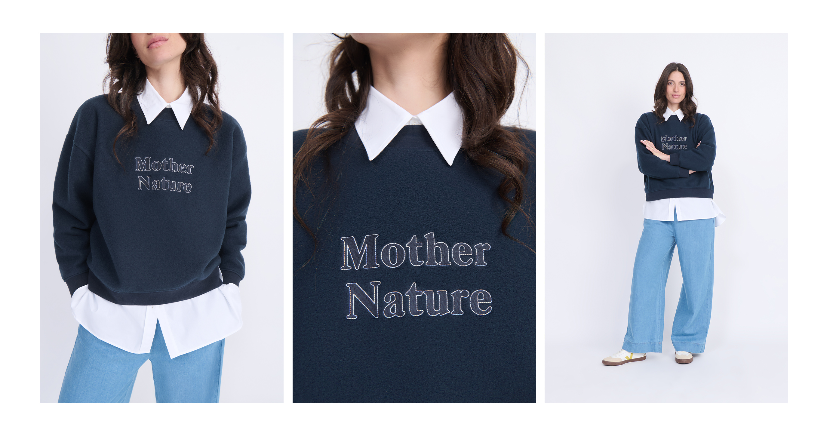 Woman wearing a navy sweatshirt with "Mother Nature" text, layered over a white shirt, paired with light blue jeans.