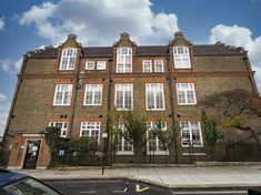 image of a red brick primary school with three stories