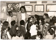 Black and white image of Beryl Gilroy and pupils in a classroom