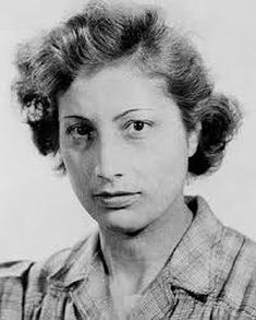 Noor Inayat Khan, a young woman of Indian heritage. Her brown hair is short and wavy and she is wearing a checked blouse.