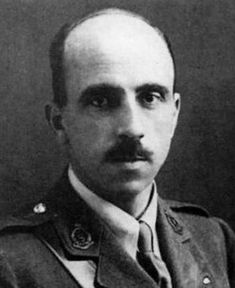 a black and white image of a balding man, with a moustache in an army uniform