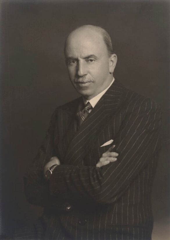 black and white image of a man wearing a pinstripe suit