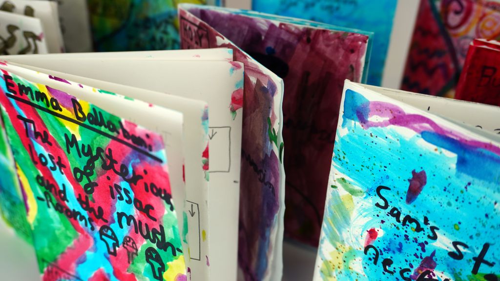 a selection of handmade paper books painted in bright colours