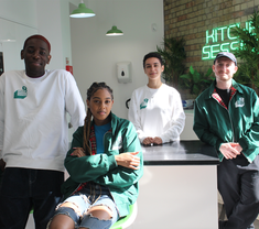 group of four people looking at camera