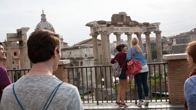EF Language Abroad students sightseeing at the Roman Forum in Rome, looking out over the ancient ruins and historic columns from a scenic overlook.