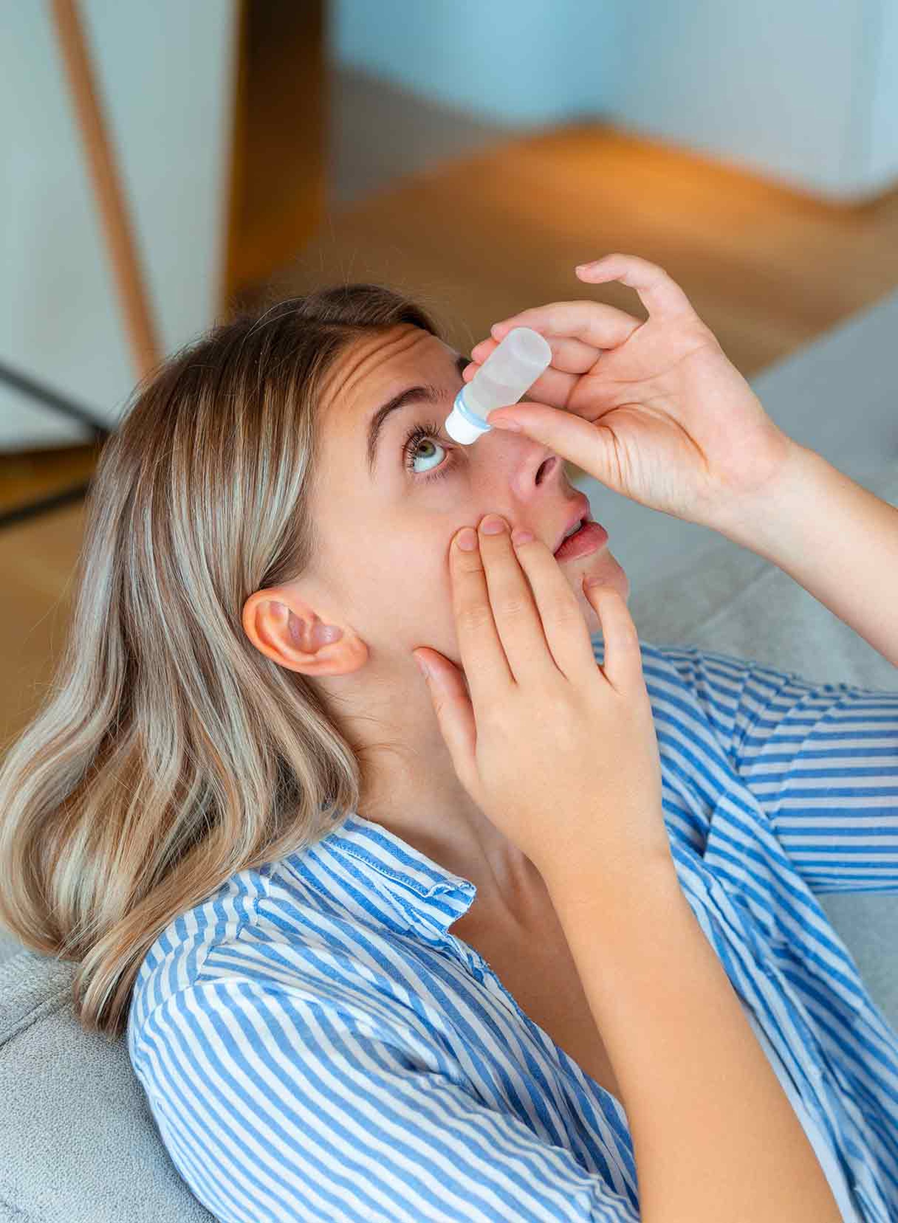 Una ragazza applica un collirio per la secchezza oculare causata dal laser per la miopia