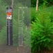 A roll of fencing material labeled "Forst," with measurements, is displayed beside a lush green conifer tree in a forest setting.