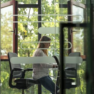 Man sitting with a headset in front of a computer.