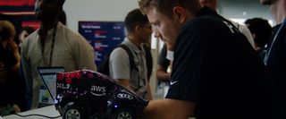 A guy is working on his laptop during DeepRacer