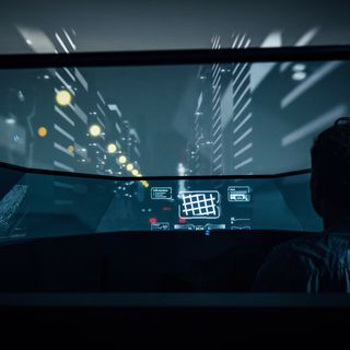 person sits in a futuristic audi at night