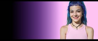 Person with blue hair in front of a pink wall