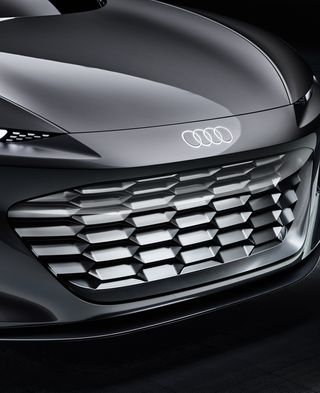 front of a futuristic gray Audi