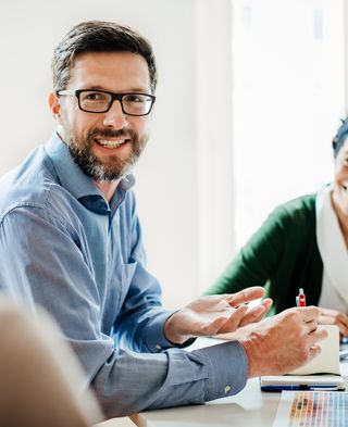 several people sit at the table and talk
