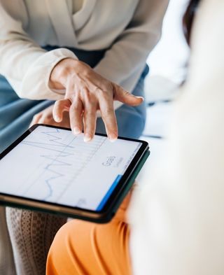 person shows something on the tablet with his hands