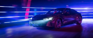 black audi at night in front of a blue background