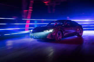 black audi at night in front of a blue background