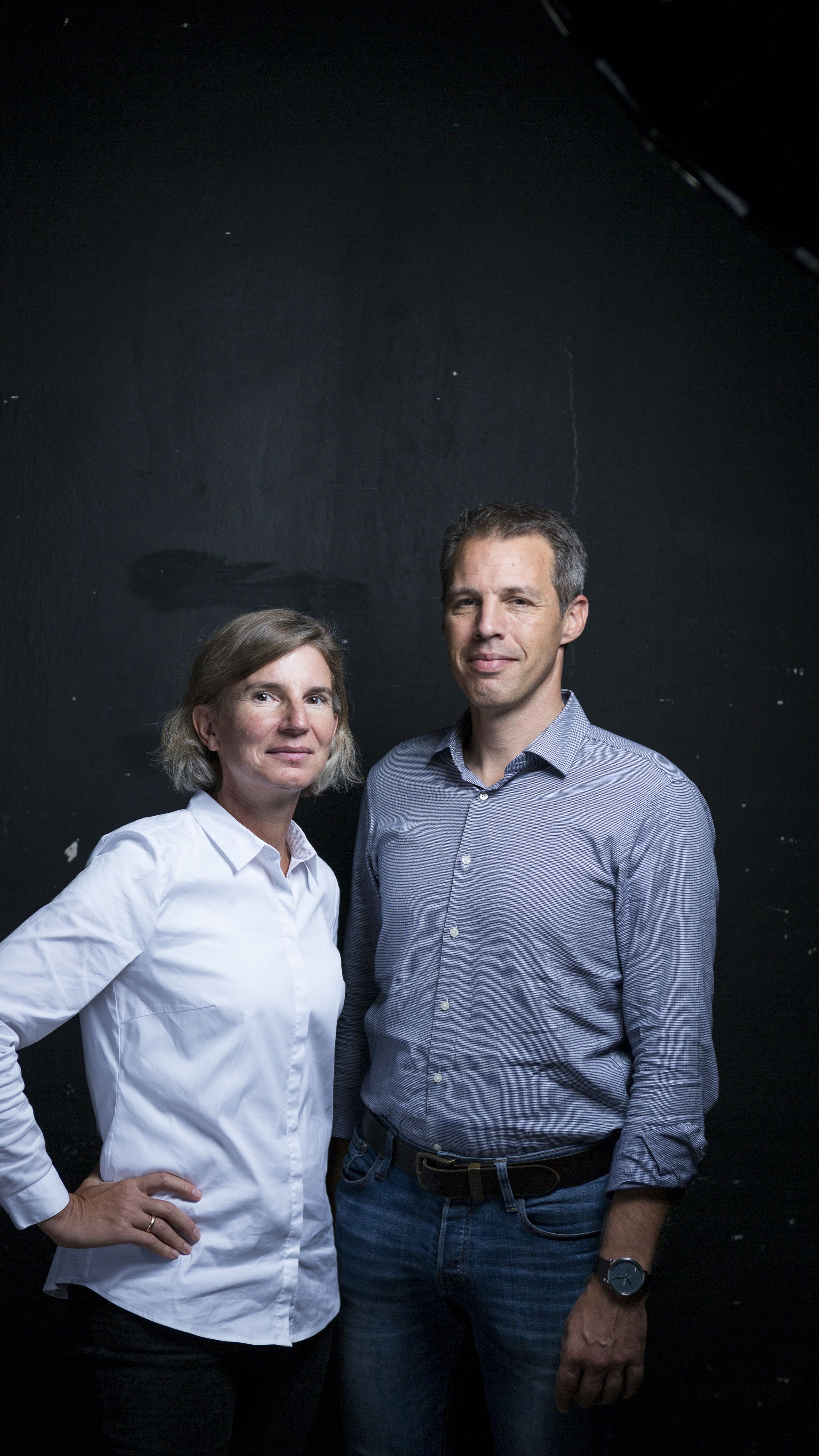 Susanne König (CEA and Co-founder) and Martin Schichtel (CEO and Co-founder) of Kraftblock, part of RESPOND cohort #1. A woman in a white shirt and a man in a blue shirt stand against a dark background, both looking at the camera with neutral expressions.