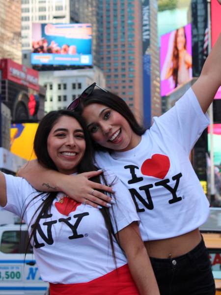 Two girls in New York, with t-shirts saying "I love NY"