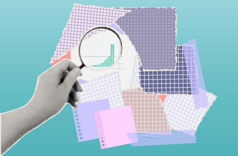 Collage of torn graph paper sheets with a hand holding a magnifying glass focusing on a rising bar chart