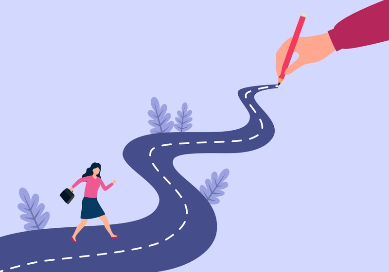 Illustration of a woman walking on a winding road being drawn by a large hand holding a pencil