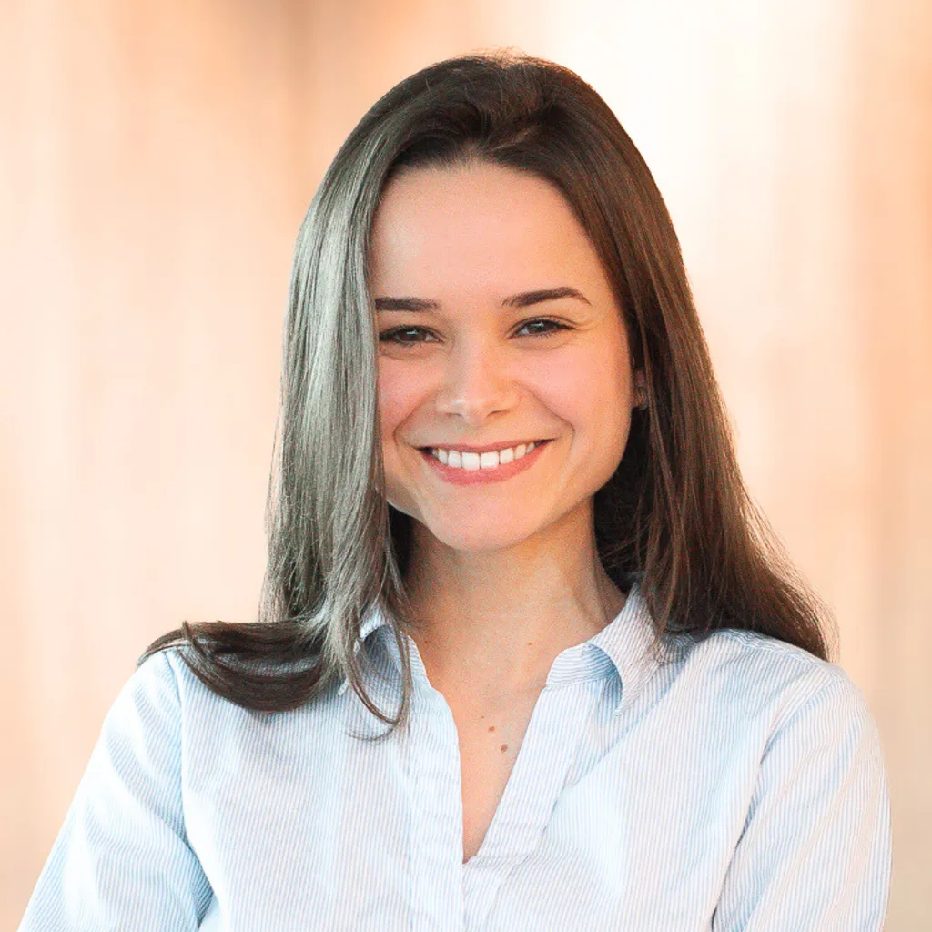 headshot of brunette colleague smiling in the camera