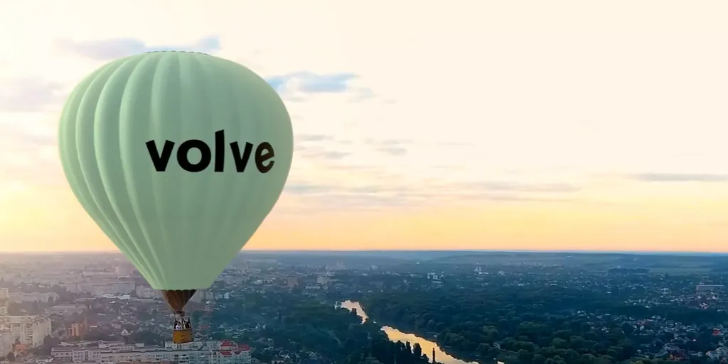 Flying balloon in the sky with Volvo logo on it.