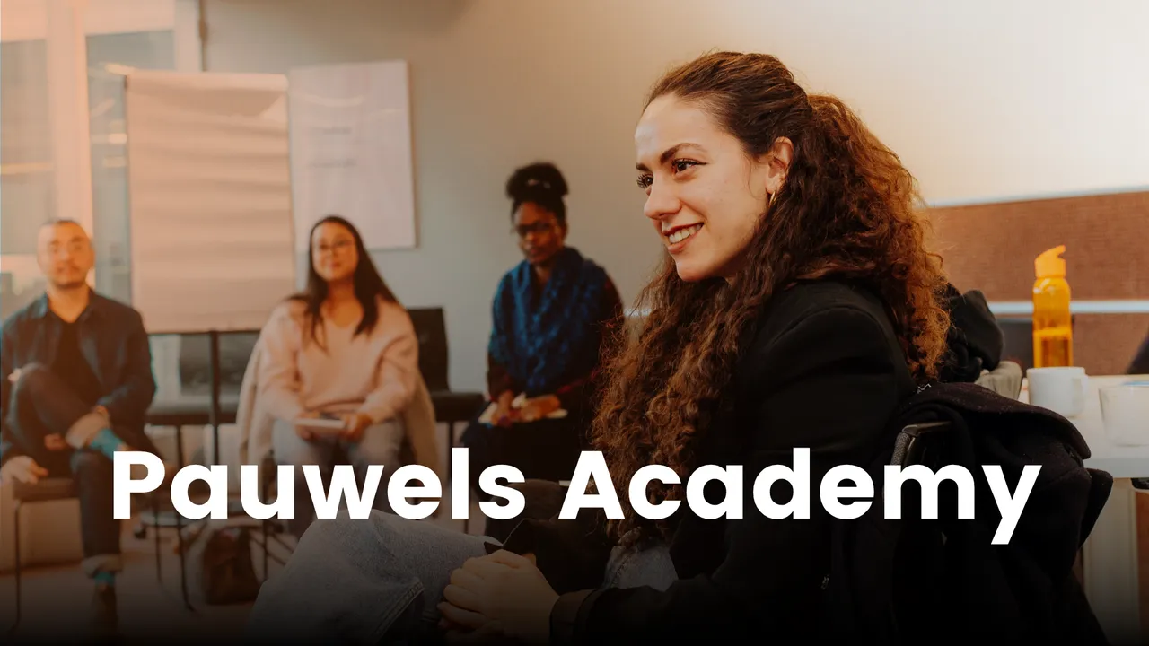 A group of people sitting in a room with a woman in focus smiling, and "Pauwels Academy" text overlay at the bottom.