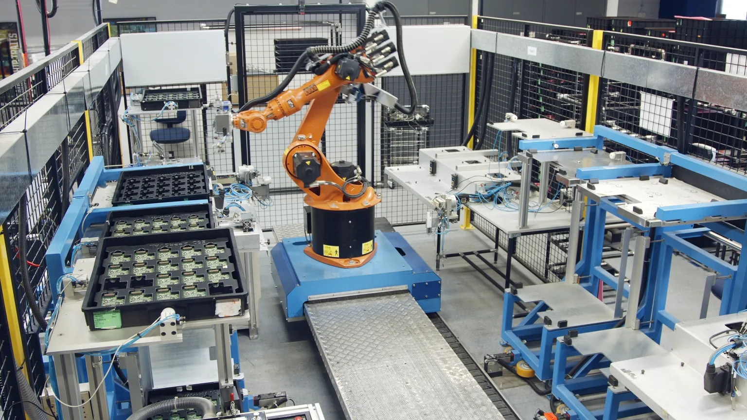 A robot operates efficiently in a factory, managing items on a conveyor belt during the production process.