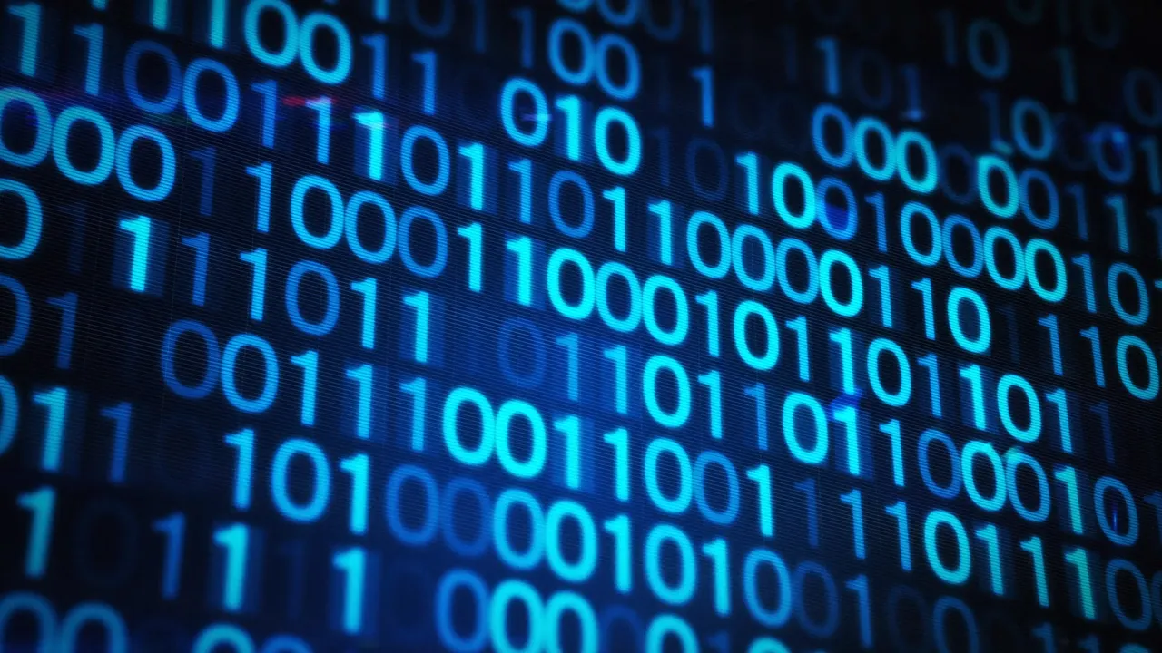 A close-up view of a computer screen displaying a sequence of binary numbers in green on a dark background.