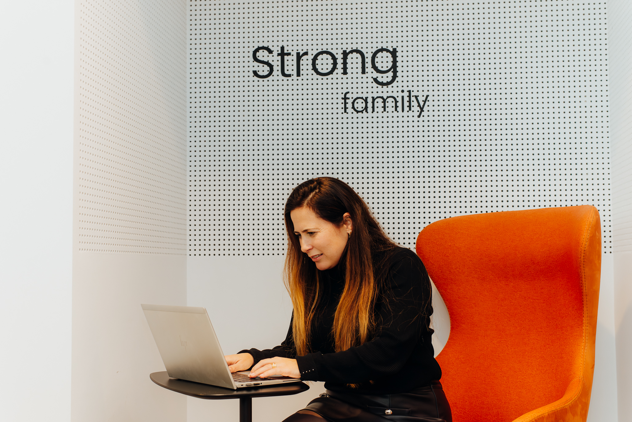 Woman using laptop in modern space with 