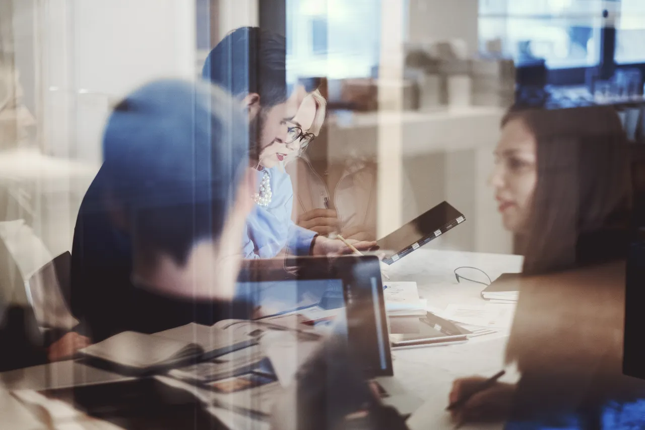 IT professionals are working together at a desk
