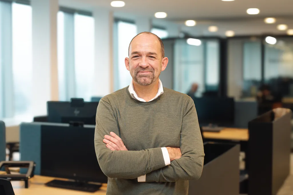 headshot of Bert Pauwels standing in front of the camera arms crossed smiling