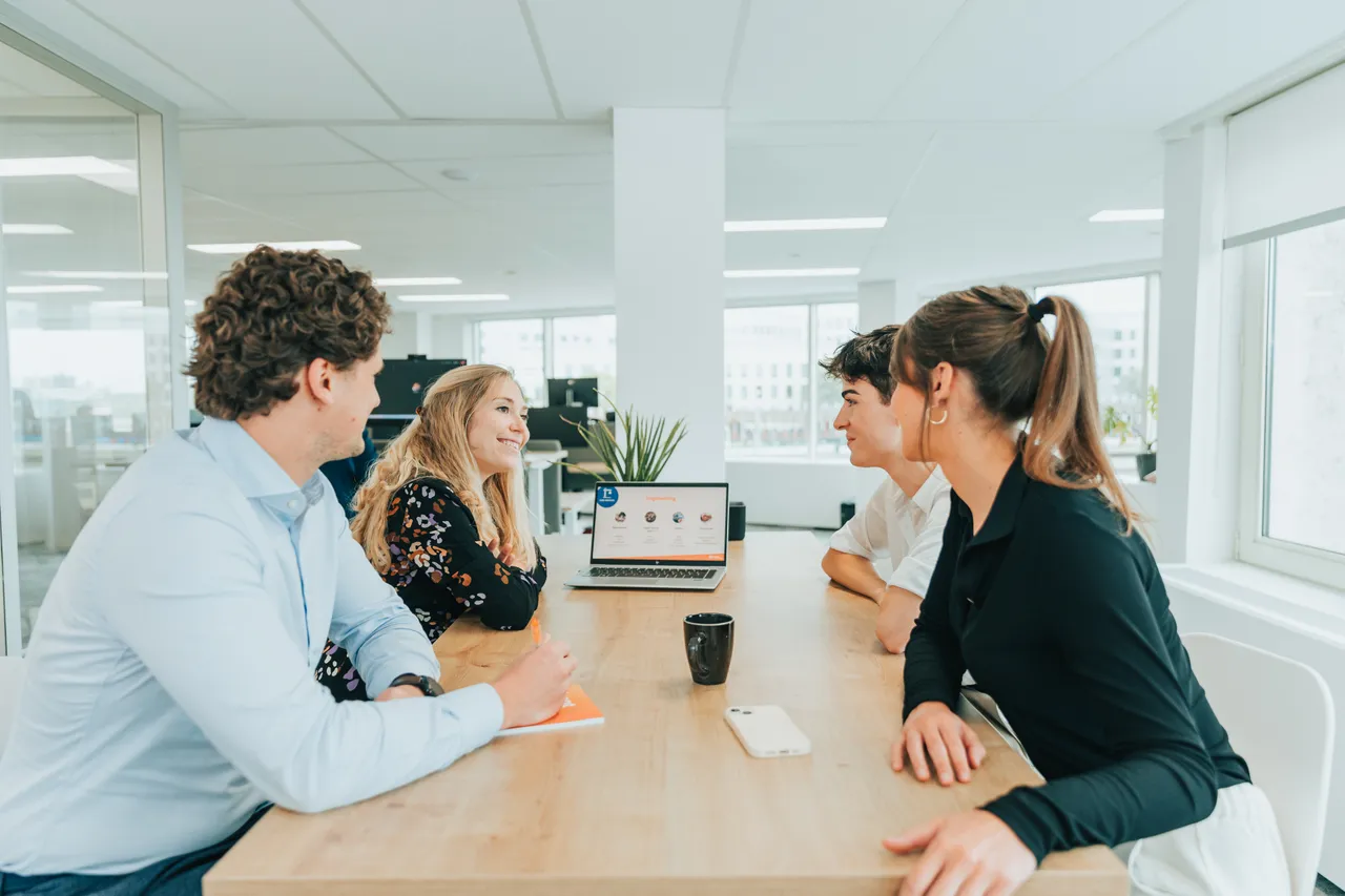 Colleagues sitting on desk in presentation modus.