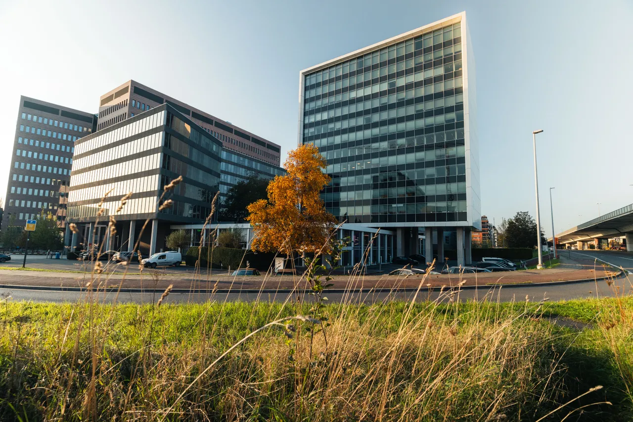 Full shot of our Ghent Office from the outside with blue sky