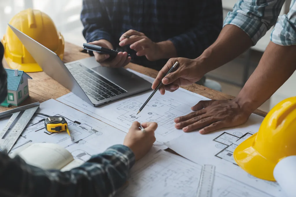 Architectural engineer team meeting Drawing and calculations for architectural structures and engineering tools in the workplace. Structural and technical construction concepts.