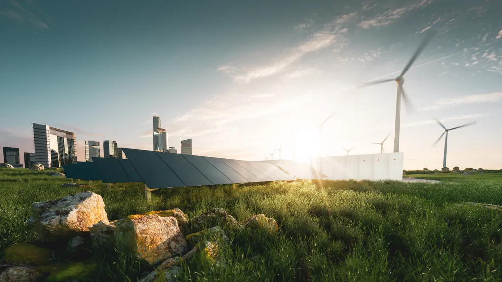 Concept of sustainable energy solution in beautiful sunset backlighting. Frameless solar panels, battery energy storage facility, wind turbines, and a large city with skyscrapers in the background.