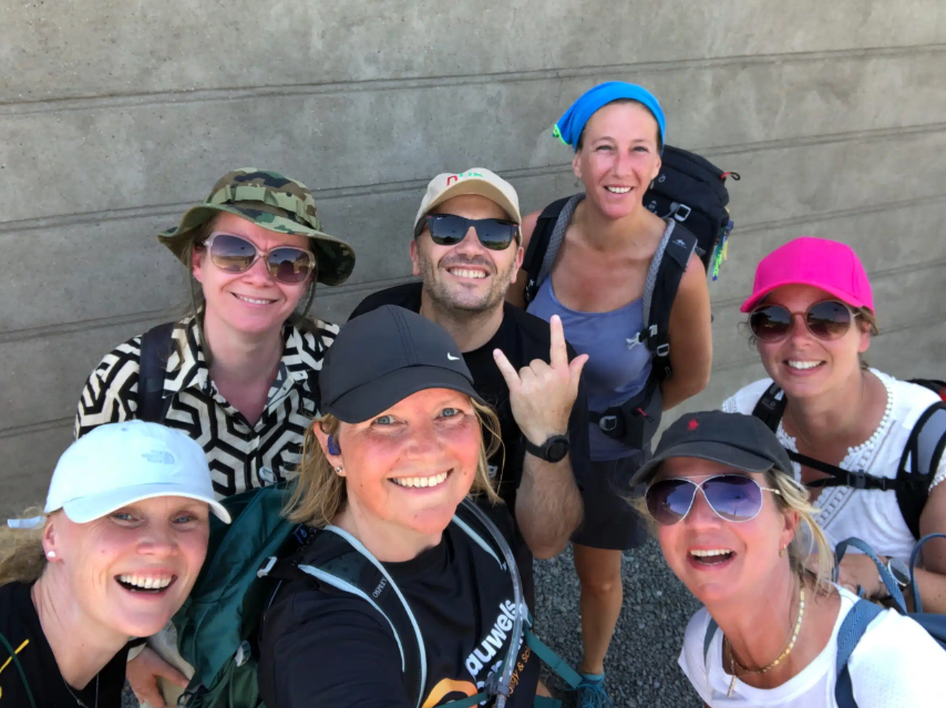 A group of people happily taking a selfie, highlighting their friendship and shared moment in a bright, social atmosphere.