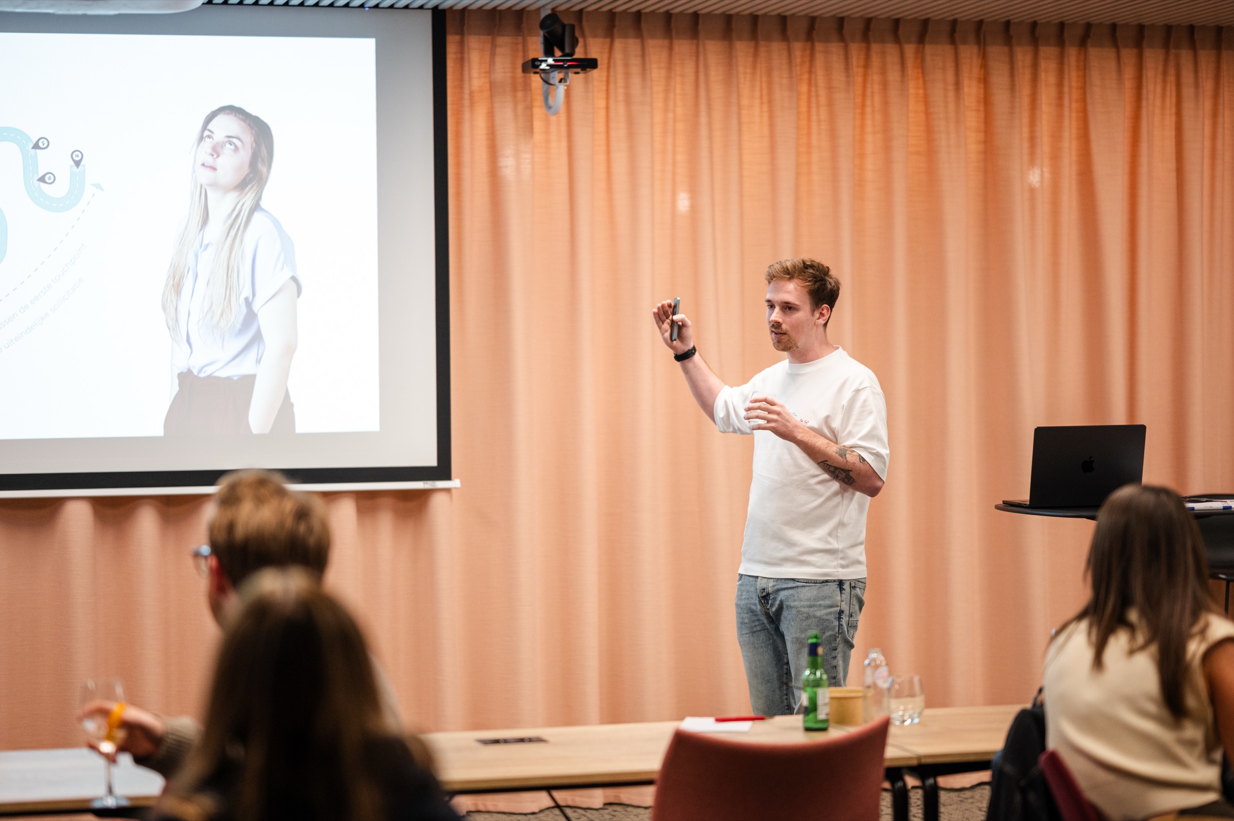 Jan-Bart Cassimon raises a clicker as he presents his session on HR data to the room.
