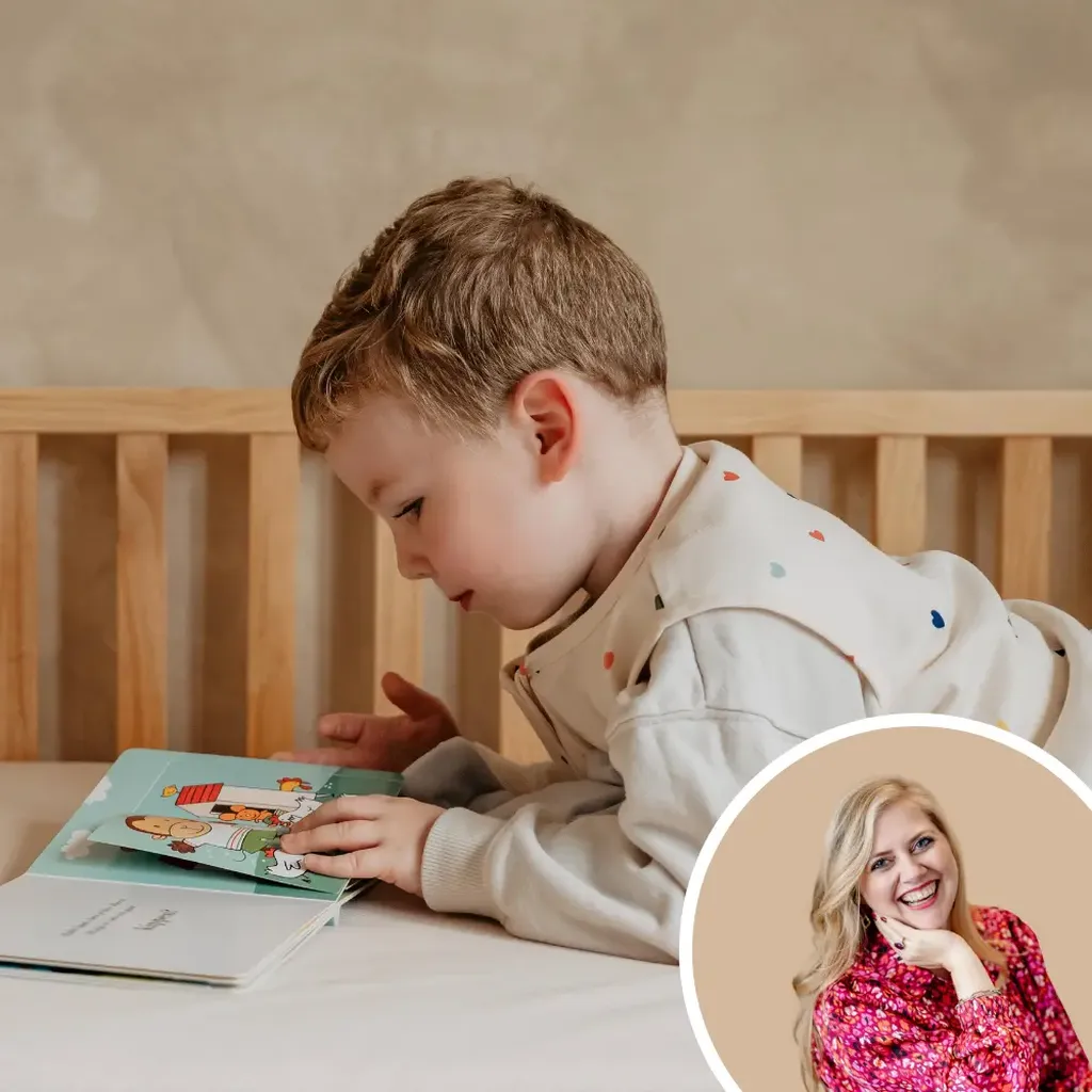 Een peuter ligt op een EvoDuo Junior-matras en leest rustig een boekje.