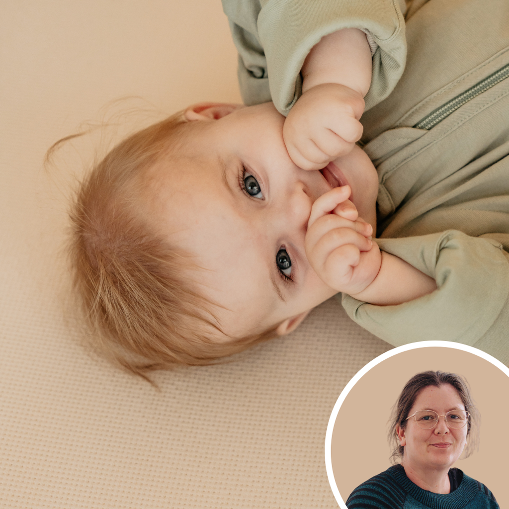 Baby lying on its back, dressed in green, smiling and sucking fingers; inset shows a woman with glasses and a gentle expression.