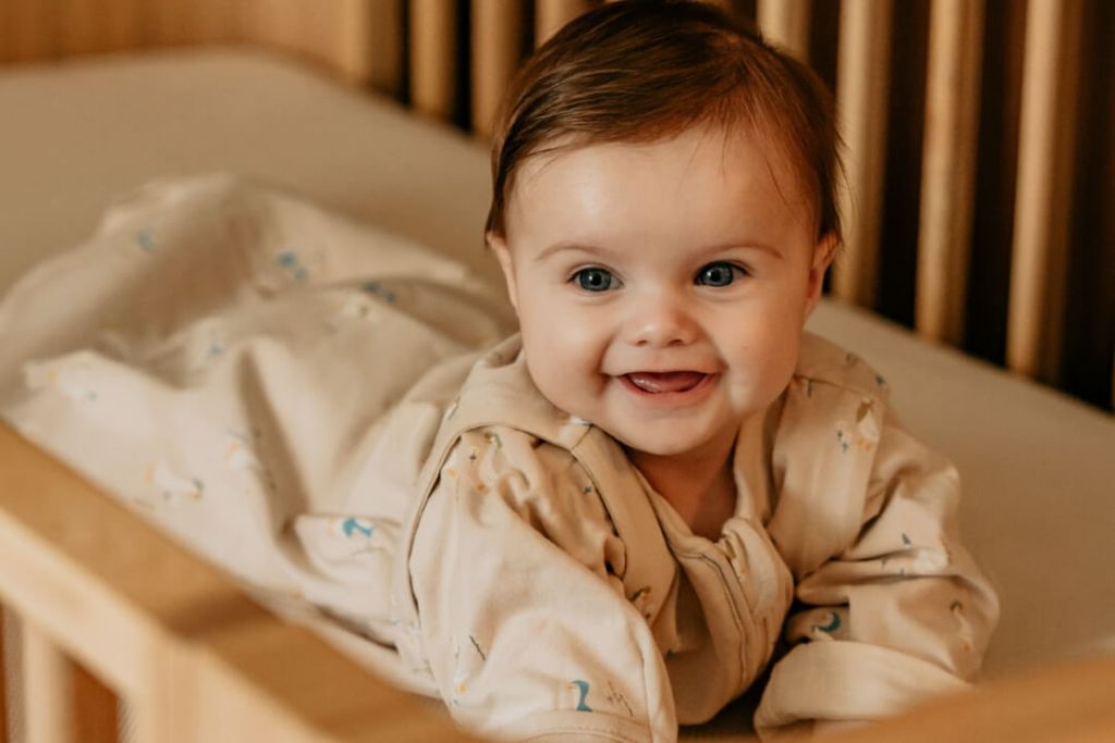 Baby in blue berries sleeping bag