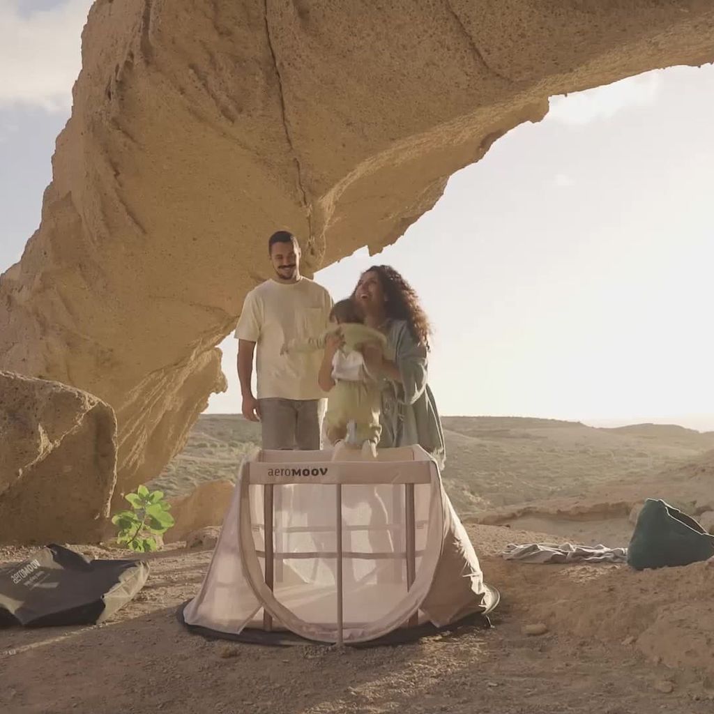 A family of 3 goes on a trip with the instant travel cot