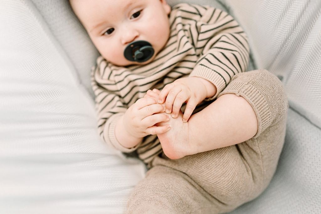 Baby sleeping in a grey baby hammock