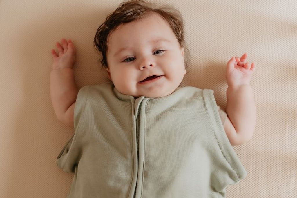 Happy baby in sleeping bag newborn without sleeves