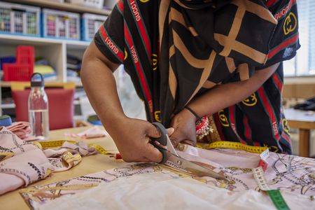 Stoffen knippen met een grote schaar.