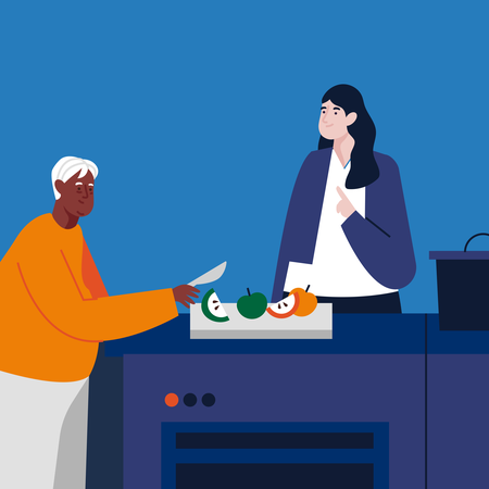 Een dame met donkerblauw vest en lang zwart haar staat in de keuken en kijkt hoe een gezette heer met licht haar twee appels doorsnijdt