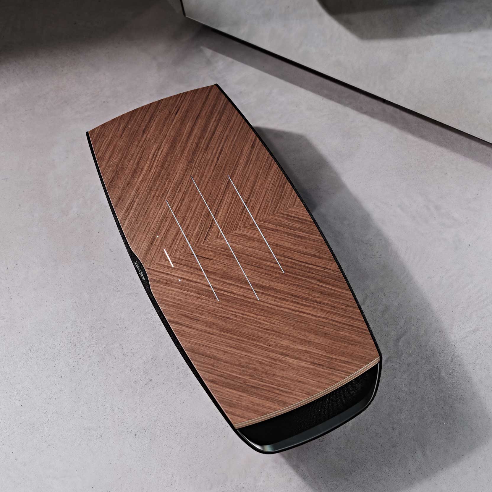 Aerial view of Sonus faber Omnia wireless bookshelf speaker in Walnut, Black fabric, and Aluminum/Titanium finishes.